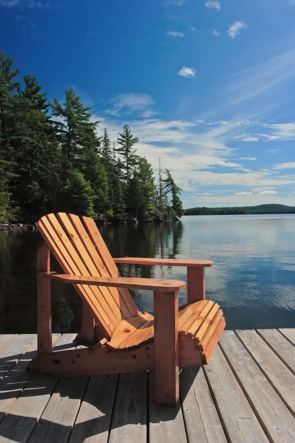 A chair on a deck at a cottage.