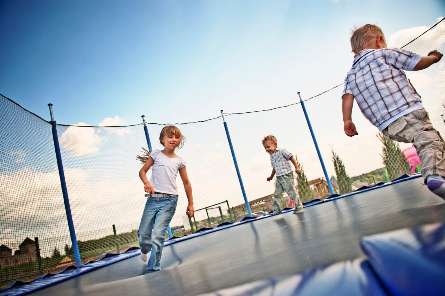 Children playing on a trampoline.