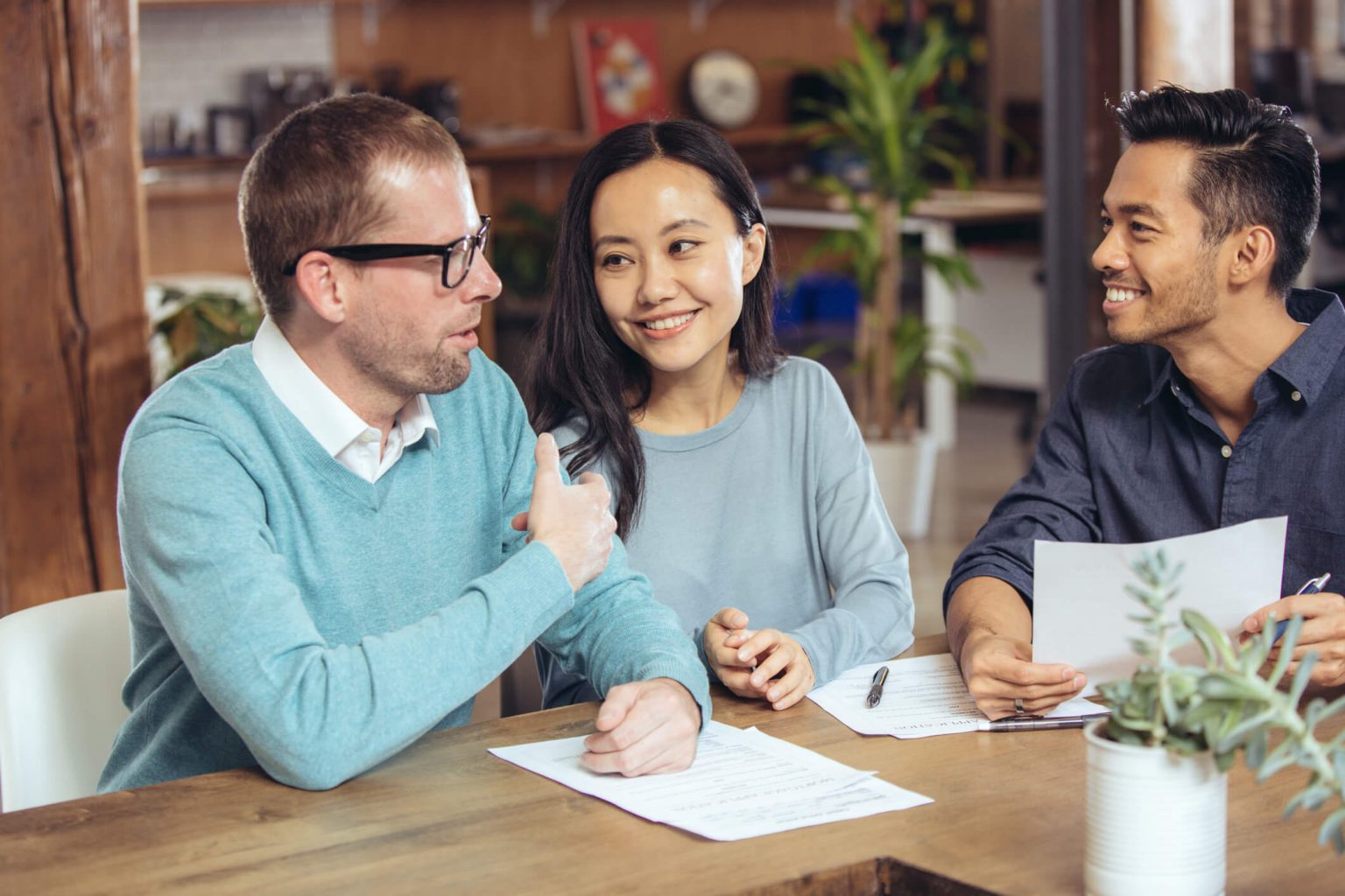 Co-workers talking over paperwork