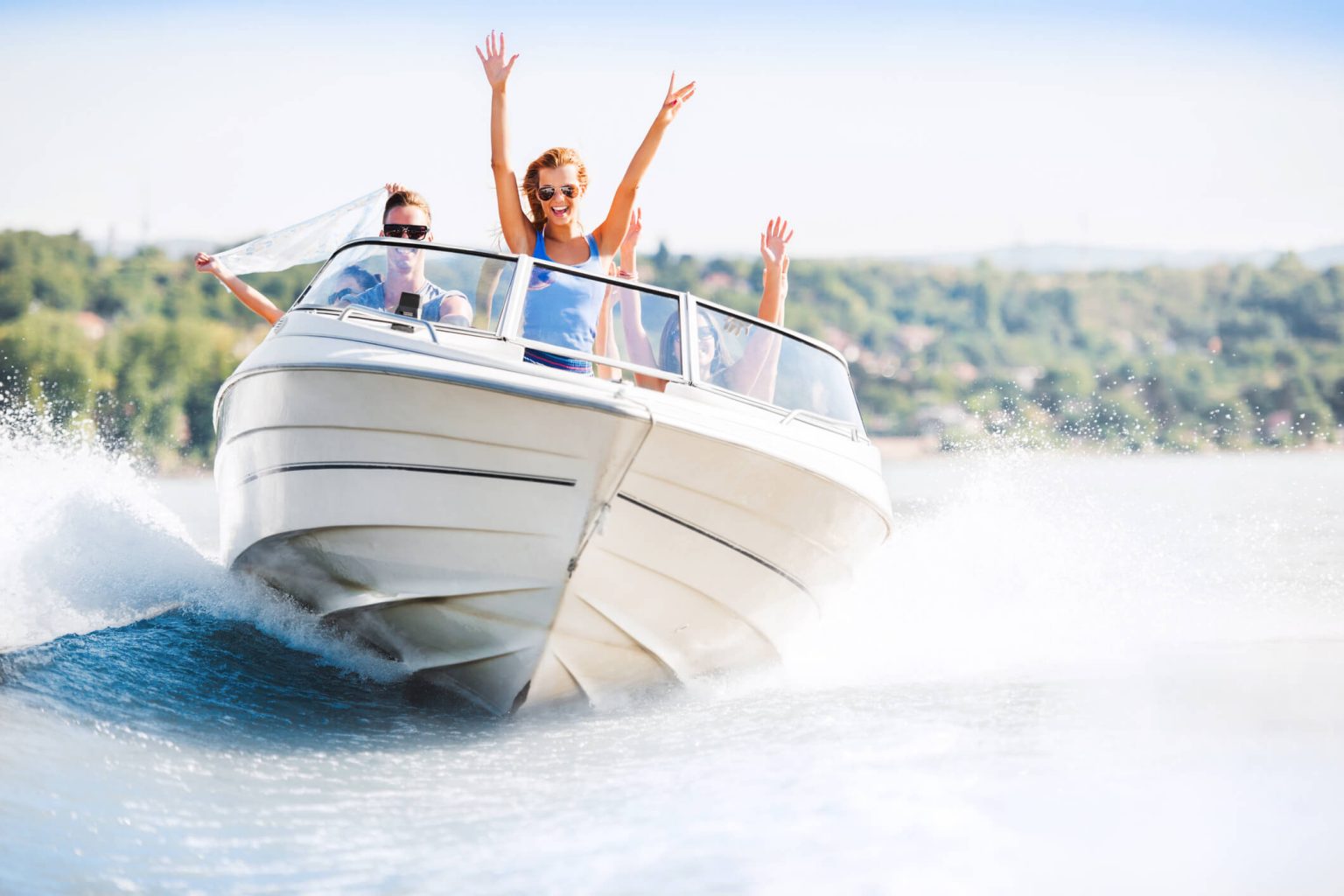 A group of people on a boat driving on the water