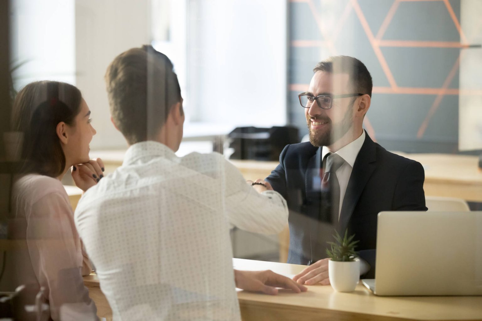 A business man talking to a couple