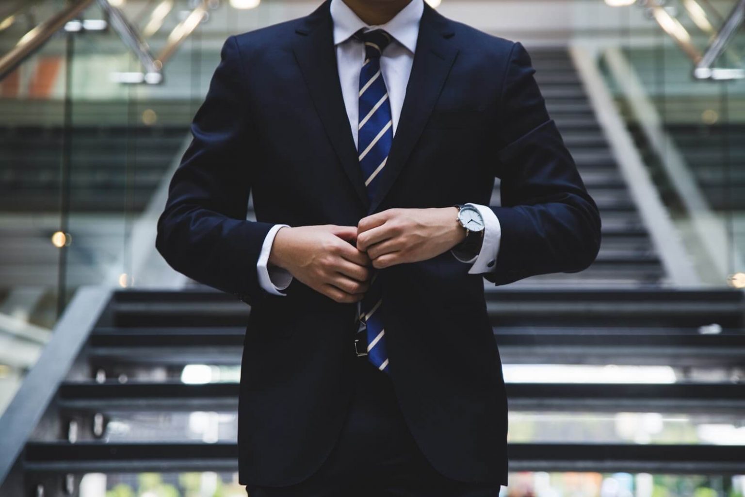 Business man doing up his jacket