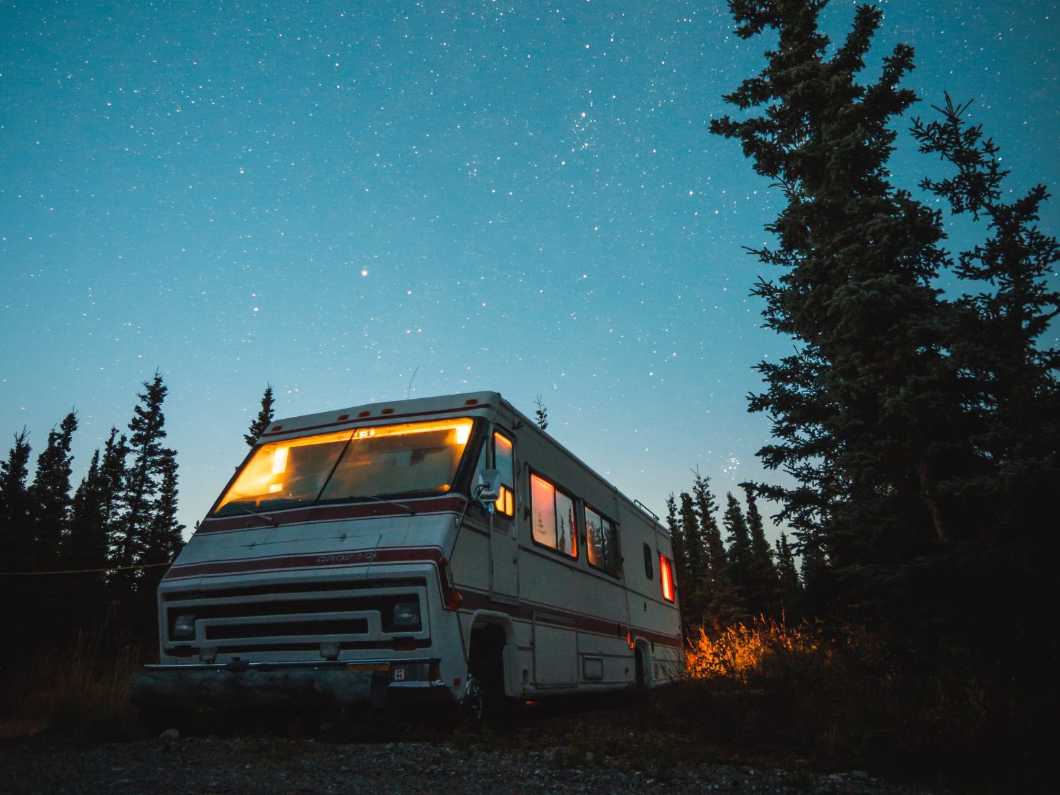 An RV that is parked under the stars.