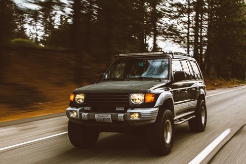 An SUV driving on a road.