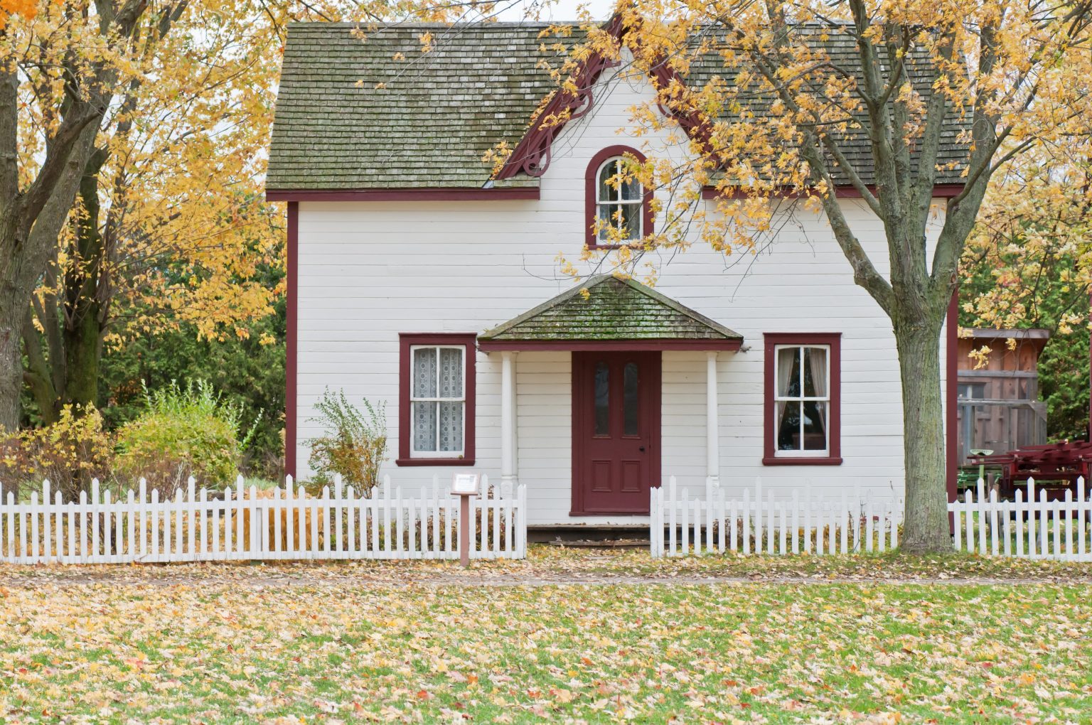 A white house with red trim and door.