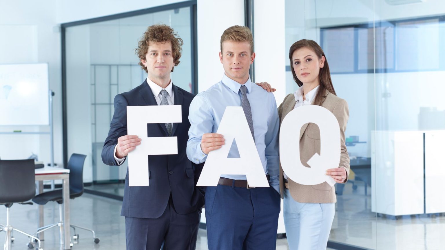 Three people holding a letter that says FAQ.