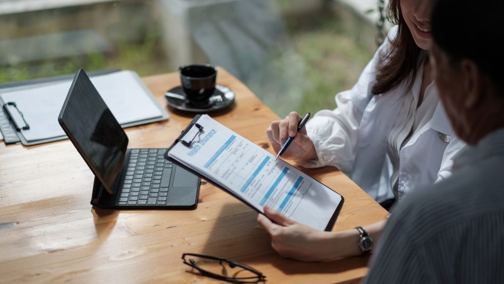 an insurance broker explaining insurance policy to client