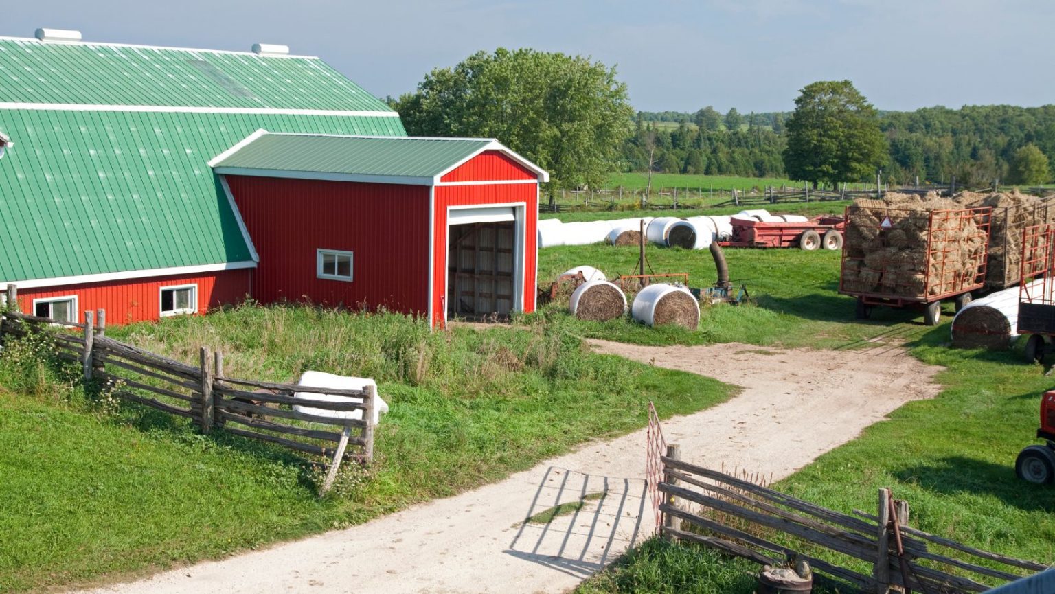A Canadian farm with a red barn.