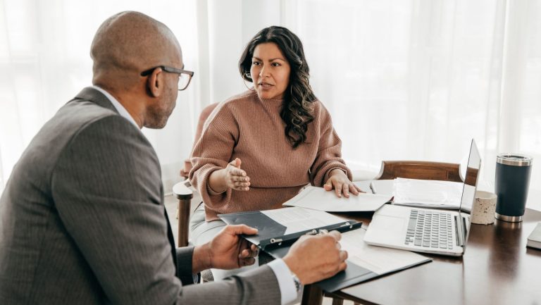 Business owner meeting with an insurance broker to discuss commercial insurance options and business coverage.