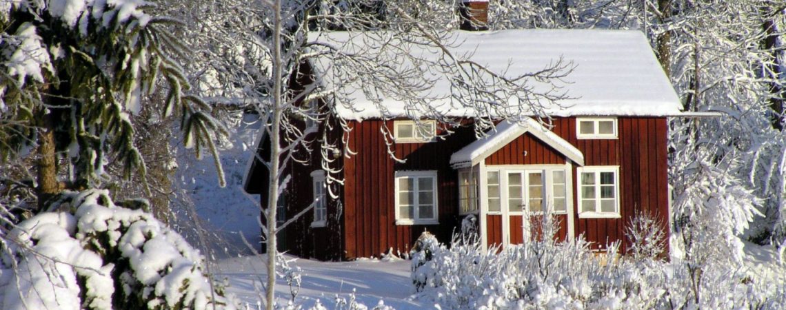 a red cottage with snow all around