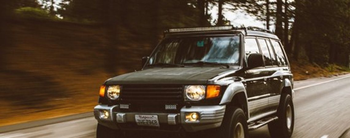 An SUV driving on a road.