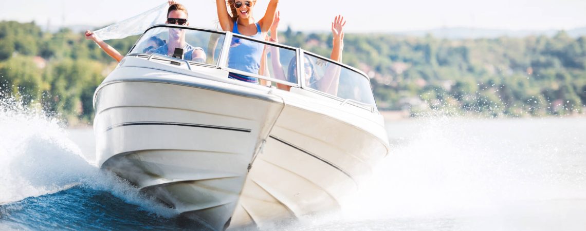 A group of people on a boat driving on the water