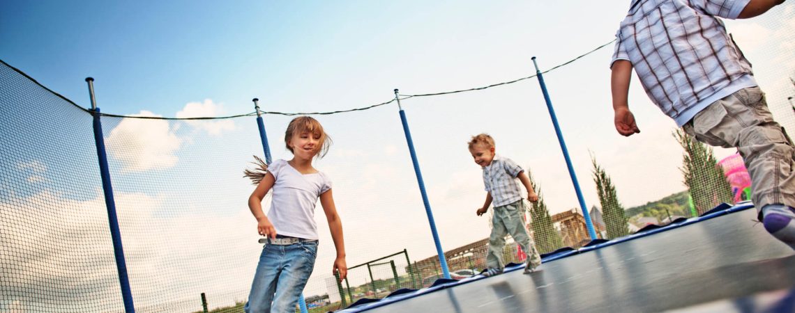 Children playing on a trampoline.