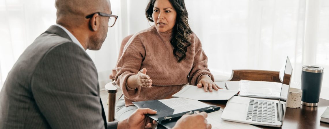 Business owner meeting with an insurance broker to discuss commercial insurance options and business coverage.