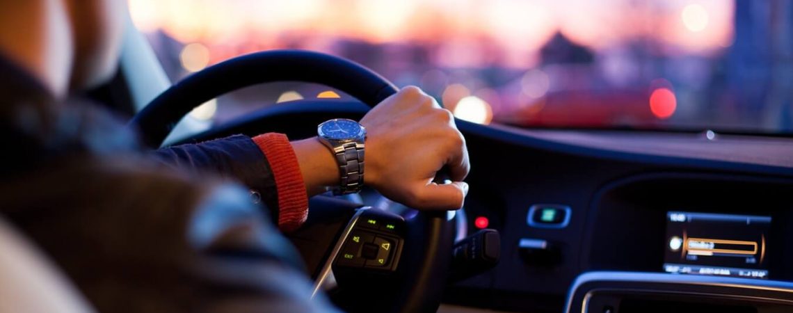 A hand on a steering wheel