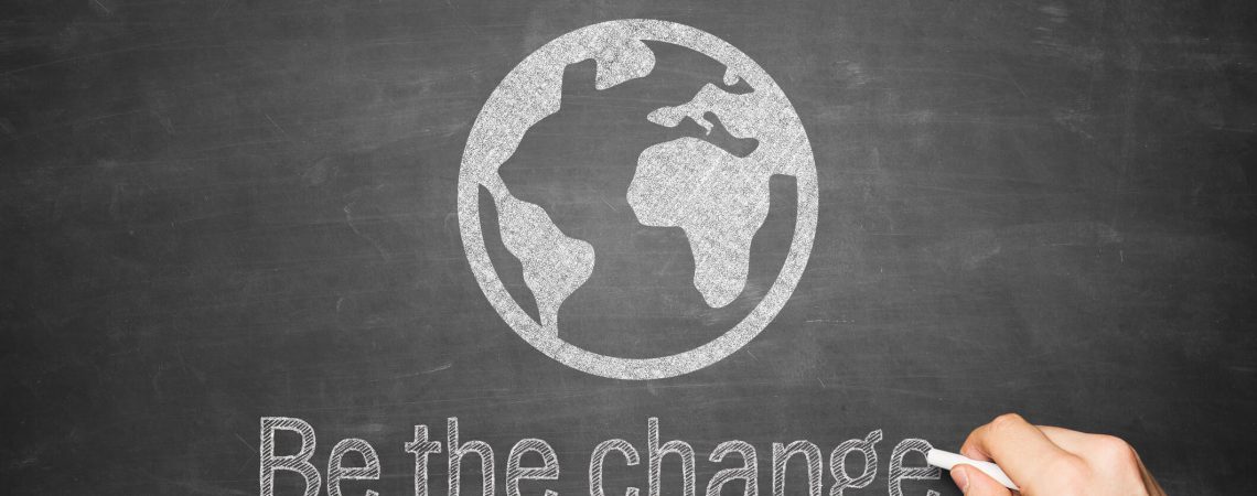 A chalkboard with a world and be the change on it.