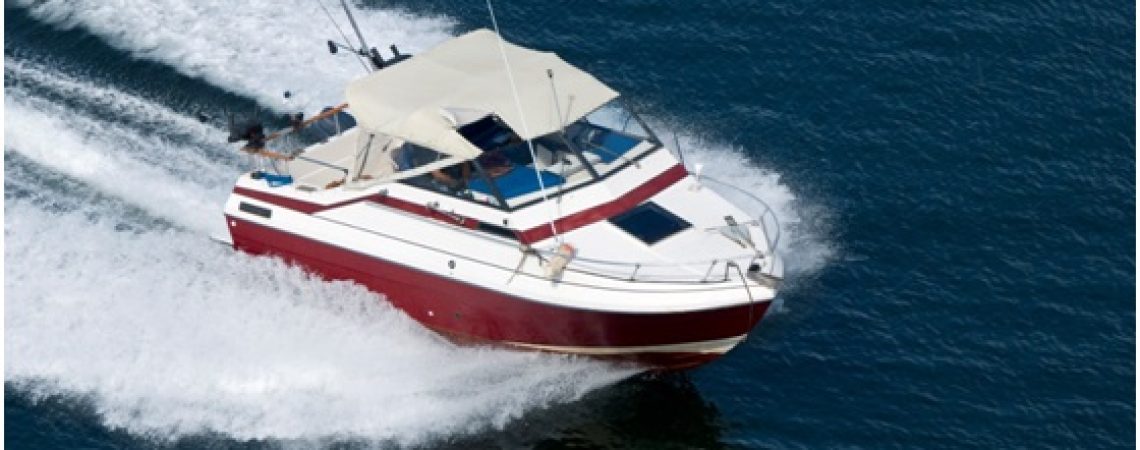 A white and red boat on the water.