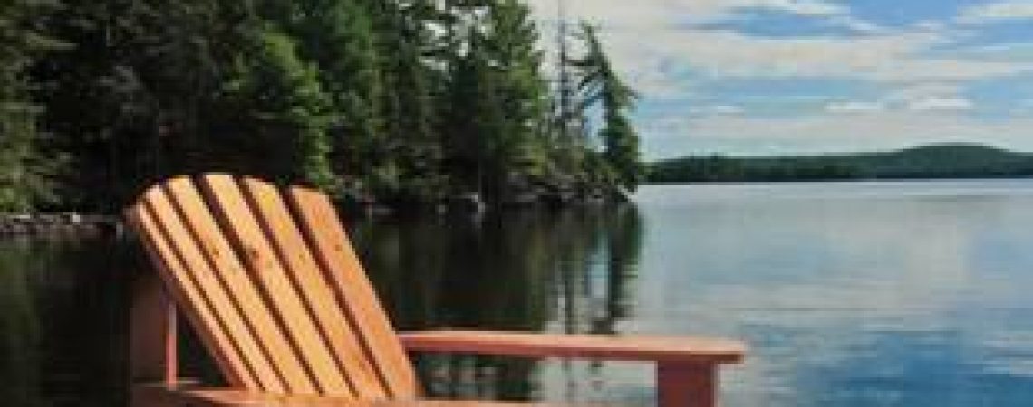 A chair on a deck by the water