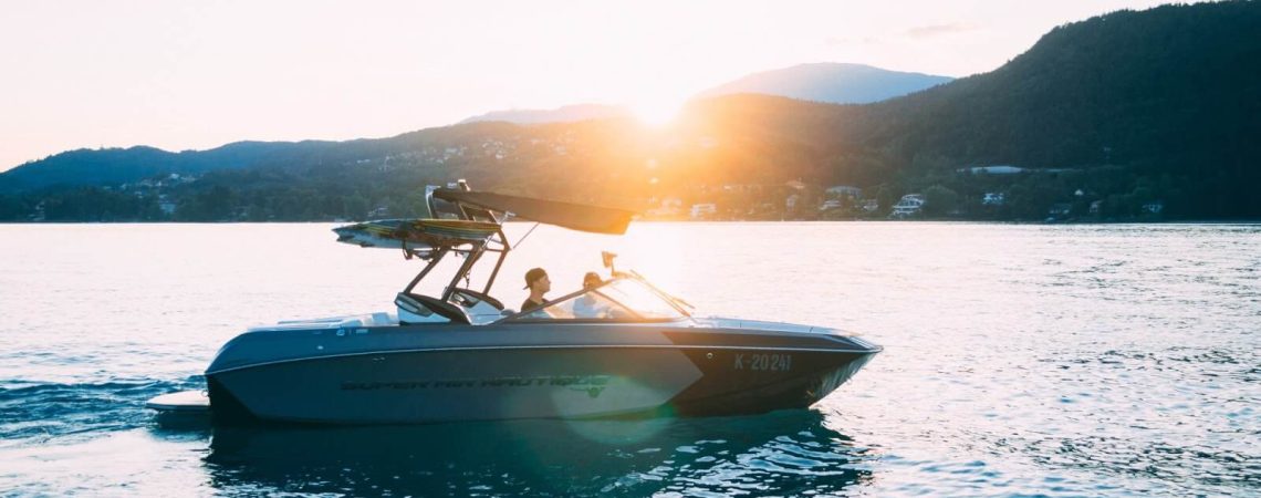 A boat on the water with two people on it.