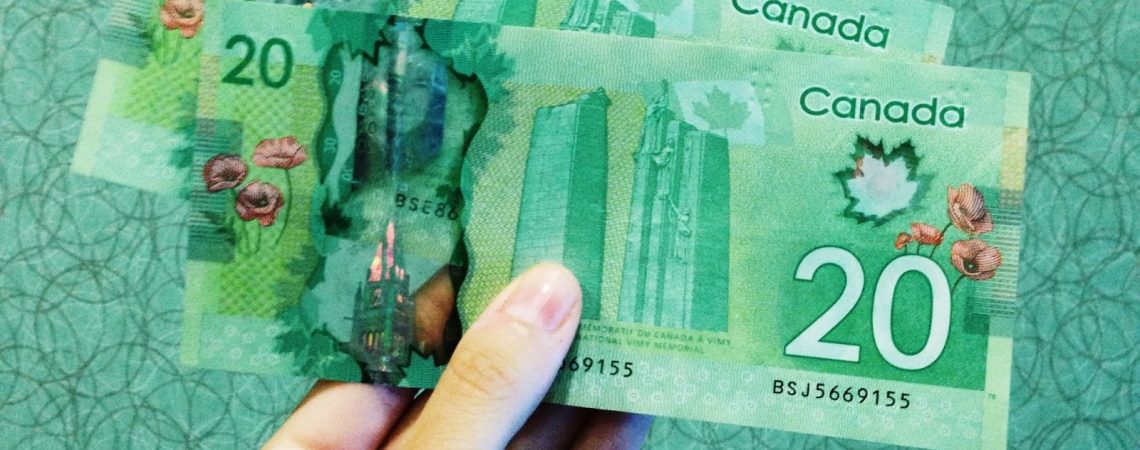a hand holding canadian money