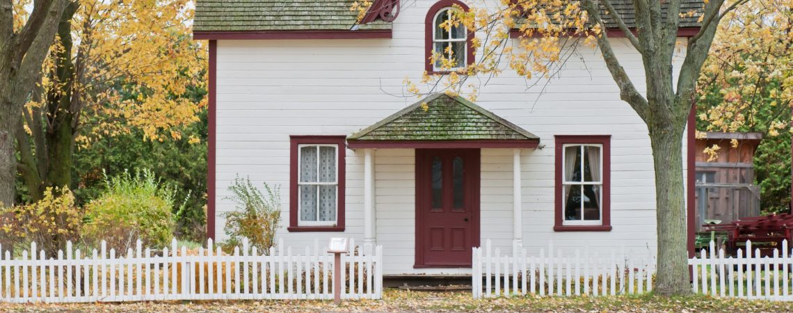 A white house with red trim and door.