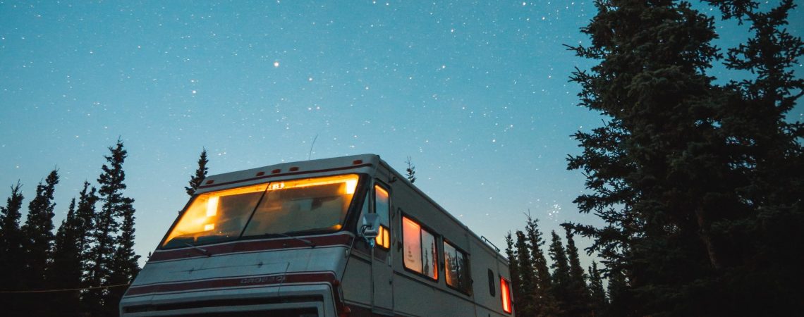 An RV that is parked under the stars.